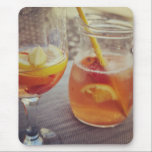 Sangria and Sunshine Mousepad<br><div class="desc">This image shows a refreshing glass and pitcher of citrus sangria, perfect for a warm day. The fresh slices of lemon and orange add bright colour and hint of natural sweetness. One glass sits ready to enjoy while sangria is being poured from a small glass pitcher beside it, perfect for...</div>