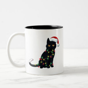 Santa Black Cat hallte in Weihnachtsbaumlicht auf Zweifarbige Tasse