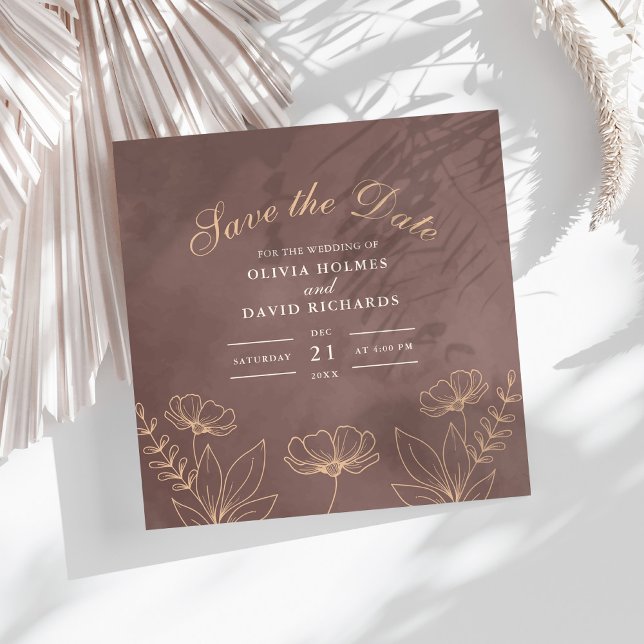 Save the Date Karte der verzauberten neutralen Blü (Enchanted Neutral Blossoms Save The Date Card on a white boho table with dry palm leaf.)