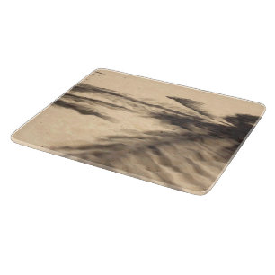 Schatten auf dem Sand Schneidebrett