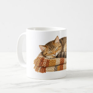 Schlafende Katze auf einer gestrickten Decke Kaffeetasse