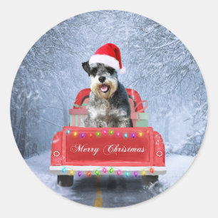 Schnauzer Hund im Schnee sitzen im Weihnachtswagen Runder Aufkleber