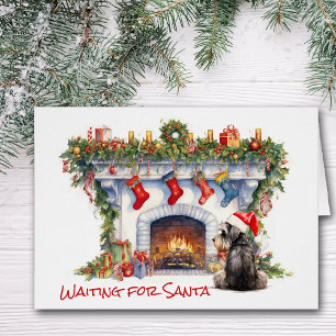 Schnauzer Terrier attend la cheminée Père Noël