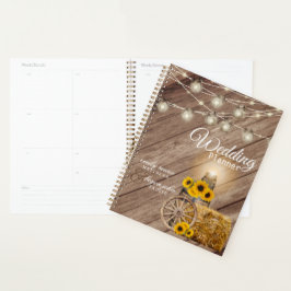 Schönes rustikales Holzfass und Sonnenblumen Planer