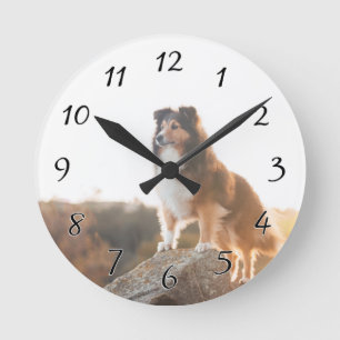 Schutz vor der Klippe bei Sonnenuntergang Runde Wanduhr