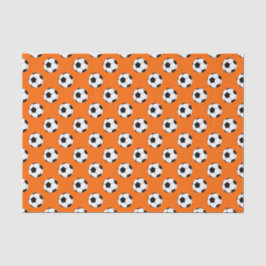 Schwarz-Weiß-Fußball-Bälle auf Orange Seidenpapier
