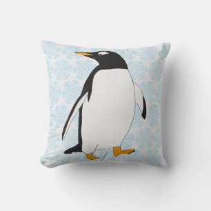 Schwarz-Weiß-Pinguin mit orangefarbenen Füßen und Kissen