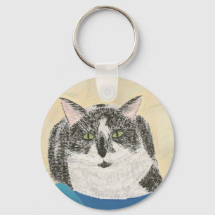 Schwarz-Weiß-Tuxedo-Katze auf blauem Schlüsselanhä Schlüsselanhänger