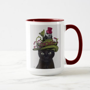 Schwarze Katze mit Teekanne und Schale Tasse