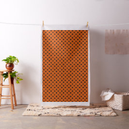 Schwarze Polka-Kreuze auf Orange Stoff