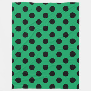 Schwarze Polka Punkte auf frisch grünem Fleecedecke