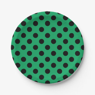 Schwarze Polka Punkte auf frisch grünem Pappteller