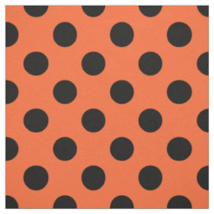 Schwarze Polka-Punkte auf Orange Stoff