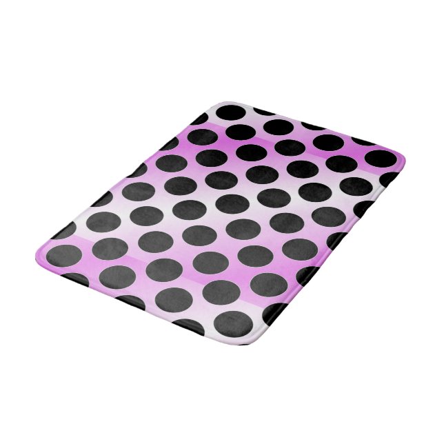 Schwarze Polka-Punkte auf Rosa Badematte (Schrägansicht)