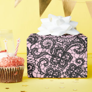 Schwarze Spitze auf rosa Geschenkpapier