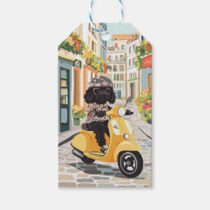 Schwarzer Doodle fährt mit Roller durch europäisch Geschenkanhänger