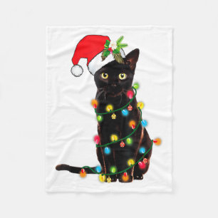 Schwarzer Katz-Santa, verheddert in Weihnachtslich Fleecedecke