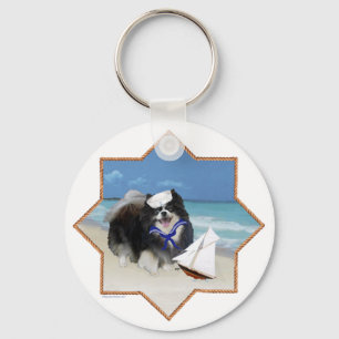 Schwarzer Pomeranian am Strand Schlüsselanhänger