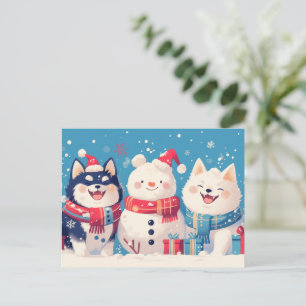 Schwarzer Shiba Inu und Samoyed-Hund mit Schneeman Feiertagspostkarte