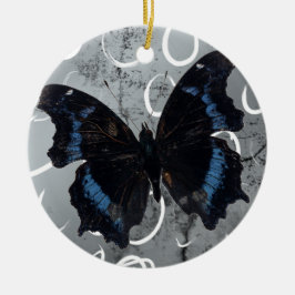 Schwarzer u. blauer Schmetterling auf silbernem Keramik Ornament
