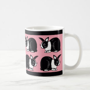 Schwarzweiss-Kaninchen rosa und schwarze Tasse