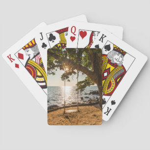 Schwingen auf dem Strand am Sonnenuntergang Spielkarten