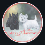 Scottie Westie Christmas Runder Aufkleber<br><div class="desc">Besuchen Sie unseren Maggie Ross Scotties Shop um alle Designs zu sehen, die Scottish Terriers und West Highland White Terriers in saisonalen Umgebungen zeigen. Maggie und Ross waren die Namen unserer Westie und Scotty Hunde und sie leben weiter in meinem Kunstwerk. Wählen Sie unser einfaches Textwerkzeug, um Ihr Design und...</div>