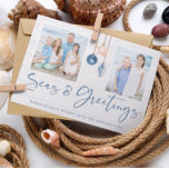 Seas and Greetings Coastal Wood Holiday Photo Feiertagskarte<br><div class="desc">Seas and Greetings Seashell Ornament on Coastal Wood Holiday Photo Christmas Cards featuring ocean navy blue and sandy tan shell ornaments hanging from sailing jute rope on coastal shiplap wood with elegant typography. Add two of your photos and a personal message for a fun nautical holiday card. Please contact us...</div>