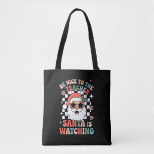 Sei nett zu dem Lehrer, der Weihnachtsmann beobach Tasche