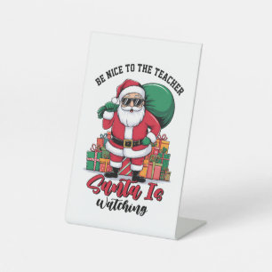 Sei nett zum Lehrer, der Weihnachtsmann beobachtet Sockelschild