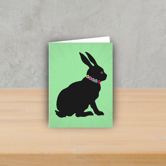 Seitenprofil Schwarze Kaninchen Blume Rosa Auge si Karte (Sitting black silhouette bunny wearing colourful flowers on green Spring or Easter note card.)