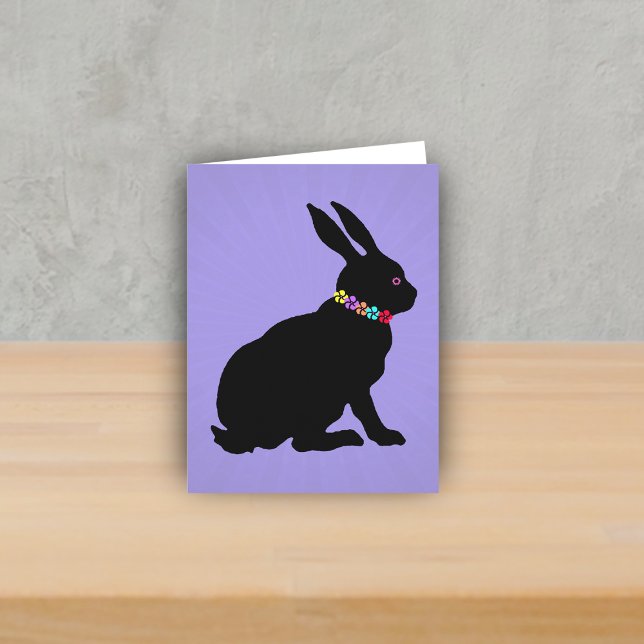 Seitenprofil Schwarze Kaninchen Blume Rosa Auge si Karte (Black sitting silhouette bunny wearing colourful flowers on purple spring or Easter note card.)
