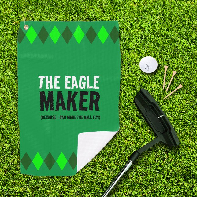 Serviette De Golf Jacquard Vert L'Aigle Maker (The Eagle Maker green argyle golf towel with putter, ball, and 3 tees on golf green)