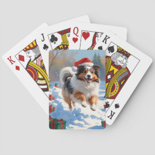 Shetland Sheepdog läuft durch Schnee mit Weihnacht Spielkarten