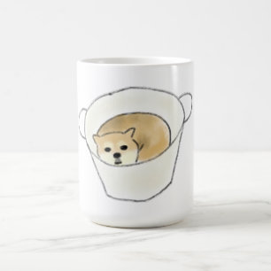 Shiba Inu Welpe ruht in weißer Tasse