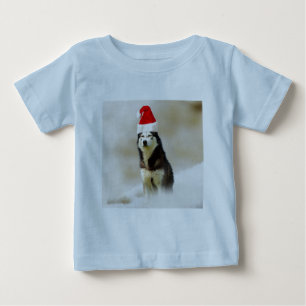 Siberischer Husky-Hund mit Weihnachtsmannmütze im  Baby T-shirt