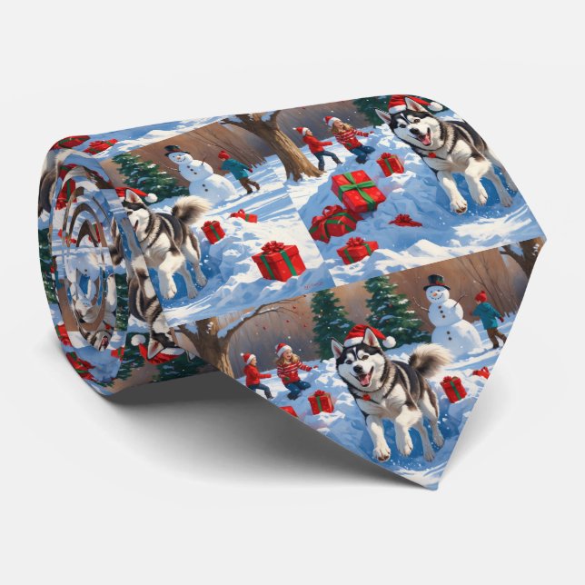 Sibirischer Husky läuft im Schnee mit Weihnachtsmü Krawatte (Gerollt)