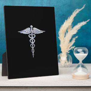 Silbernes Caduceus-Medizinsymbol auf schwarzer Dek Fotoplatte