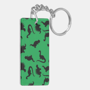 Silhouettes de dinosaures sur fond vert motif