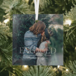 Simple Modern Elegant Engaged Photo | Christmas Ornament Aus Glas<br><div class="desc">This simple and sweet ornament says "Engaged" in trendy, modern typefaces with a quote and a spot for the year & names. Minimal one photo template of your favorite personal photo for a gift anyone would love. What a perfect way to celebrate your first Christmas together as an engaged couple!...</div>