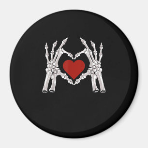 Skeletthandschuhe formen ein Herz mit rotem Herzen Magnet