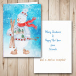 Snowman Skier Weihnachten<br><div class="desc">Die Vorderseite dieser Weihnachtskarte hat ein Aquarellbild eines niedlichen Schneemanns, der in einem Winterpulli, Hut und Schal gekleidet ist. Er hält seine Skier und Skistöcke und wird auf einem abstrakten, hellblauen Schnee und Sternhintergrund platziert. Innerhalb der Karte befinden sich Textfelder, die Sie nach Belieben anpassen können.</div>