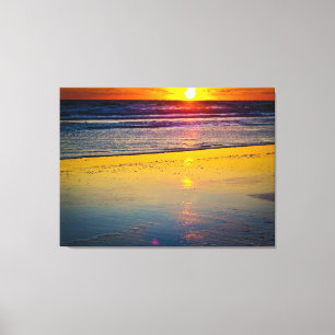 Sonnenaufgang über Ozean u. über Strand Leinwanddruck