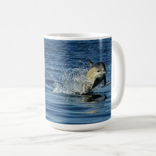 Spielende gewöhnliche Delfine springen durch den O Kaffeetasse