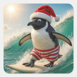 Sticker Carré Manchot de Noël surfant sur une vague océanique