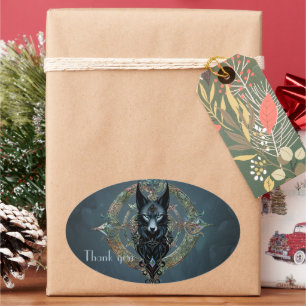 Sticker Ovale Tête de loups noirs aux yeux bleus percevants,