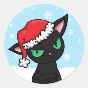Sticker Rond Chat noir grumeux portant le chapeau de Père Noël