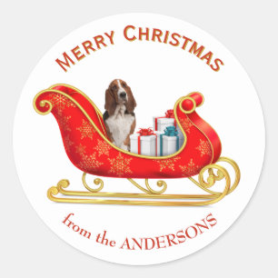 Sticker Rond Chien Basset Hound au traîneau de Noël