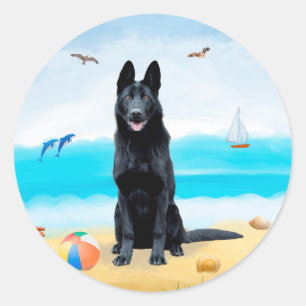 Sticker Rond Chien berger allemand noir sur la plage