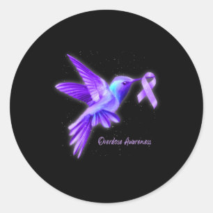 Sticker Rond Colibri tenant un surdosage du ruban pourpre